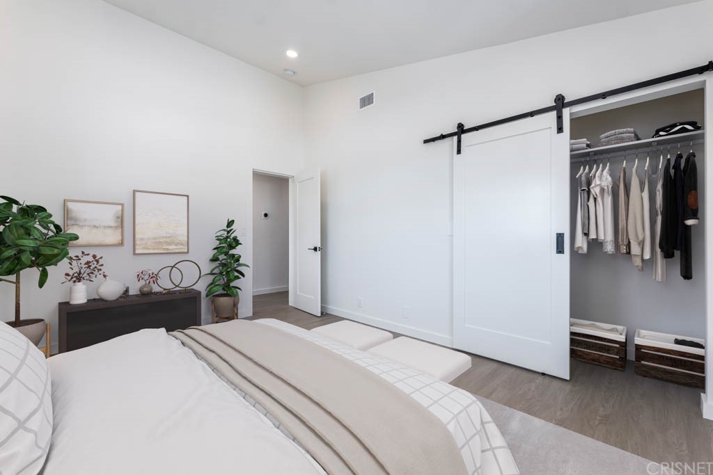 1177 Aztec Topanga, CA 90290 - Photo 52 of 65 a bedroom with a bed and a chair