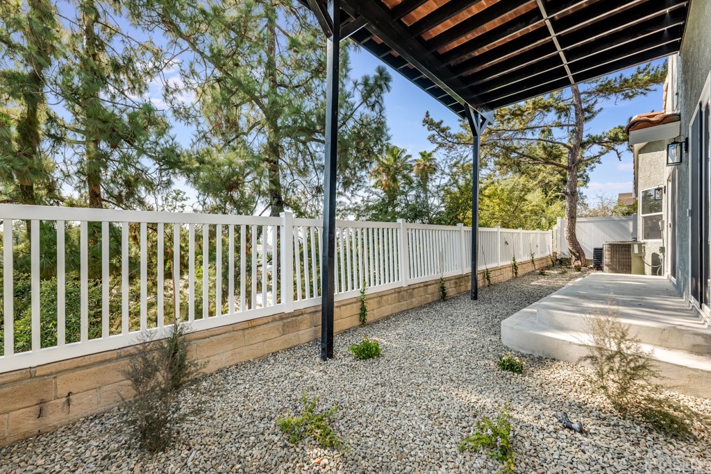 1177 Aztec Topanga, CA 90290 - Photo 55 of 65 a view of a backyard with wooden fence and large trees
