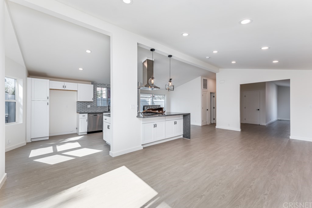 1177 Aztec Topanga, CA 90290 - Photo 6 of 65 a large white kitchen with a refrigerator a stove a sink and a cabinets