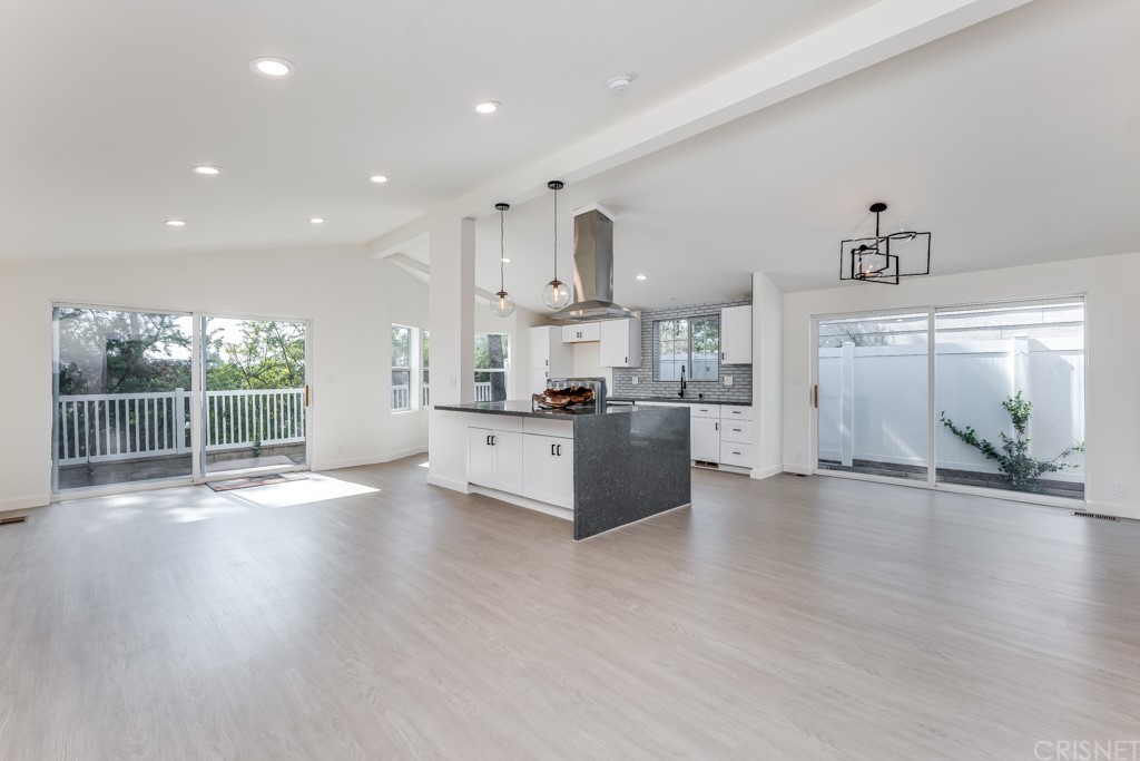 1177 Aztec Topanga, CA 90290 - Photo 8 of 65 a large open kitchen with stainless steel appliances kitchen island a stove a refrigerator a sink and a large window