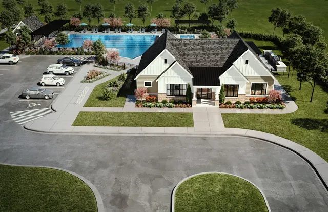 an aerial view of a house with swimming pool and garden
