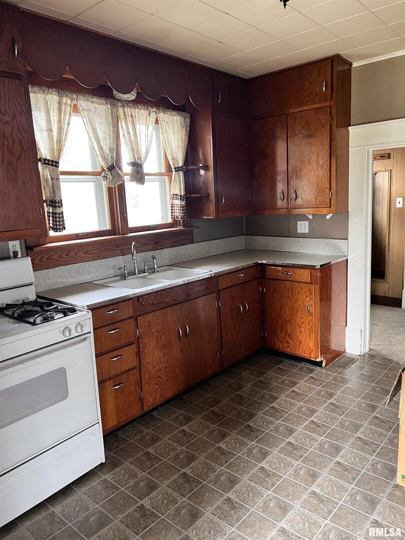 202 Wilson Street Anna, IL 62906 - Photo 14 of 18 a kitchen with stainless steel appliances granite countertop a stove a sink and a refrigerator