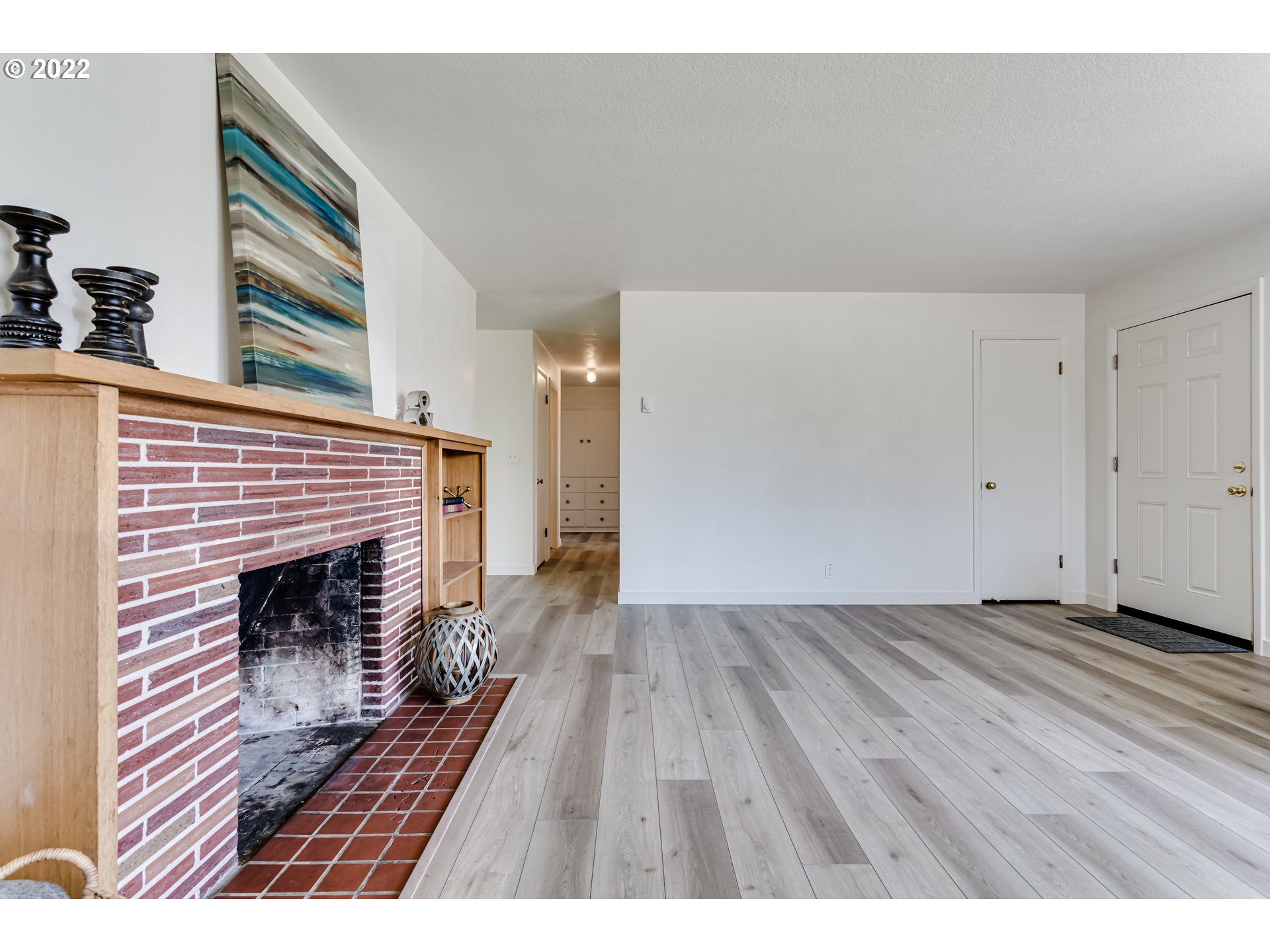2866 Manor Drive Springfield, OR 97477 - Photo 7 of 32 a view of an empty room with wooden floor and a fireplace