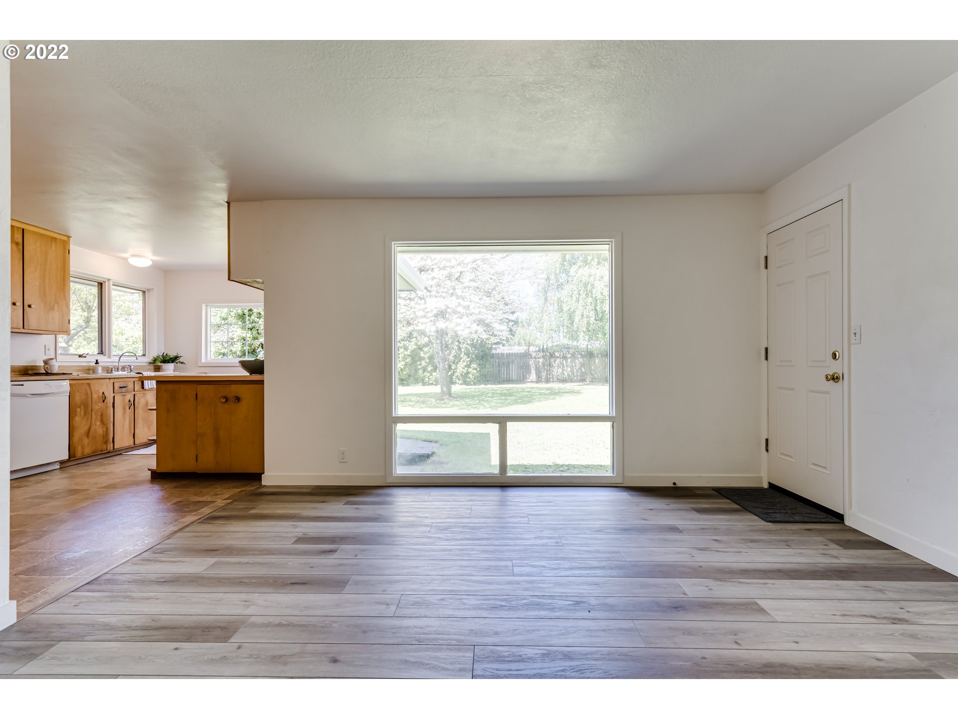 2866 Manor Drive Springfield, OR 97477 - Photo 9 of 32 a view of an empty room with wooden floor and a window
