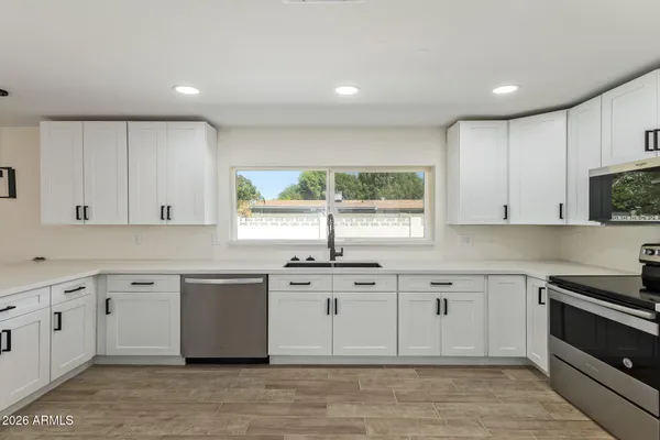 a kitchen with a sink cabinets and window