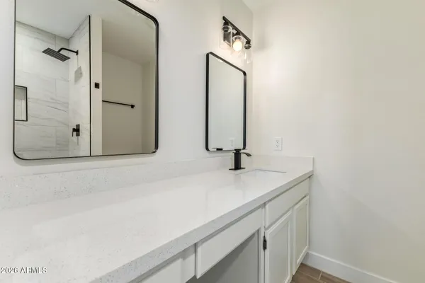 a bathroom with a sink and mirror
