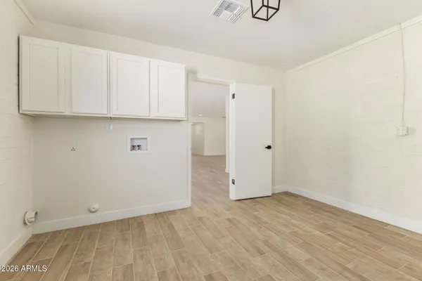 an empty room with wooden floor