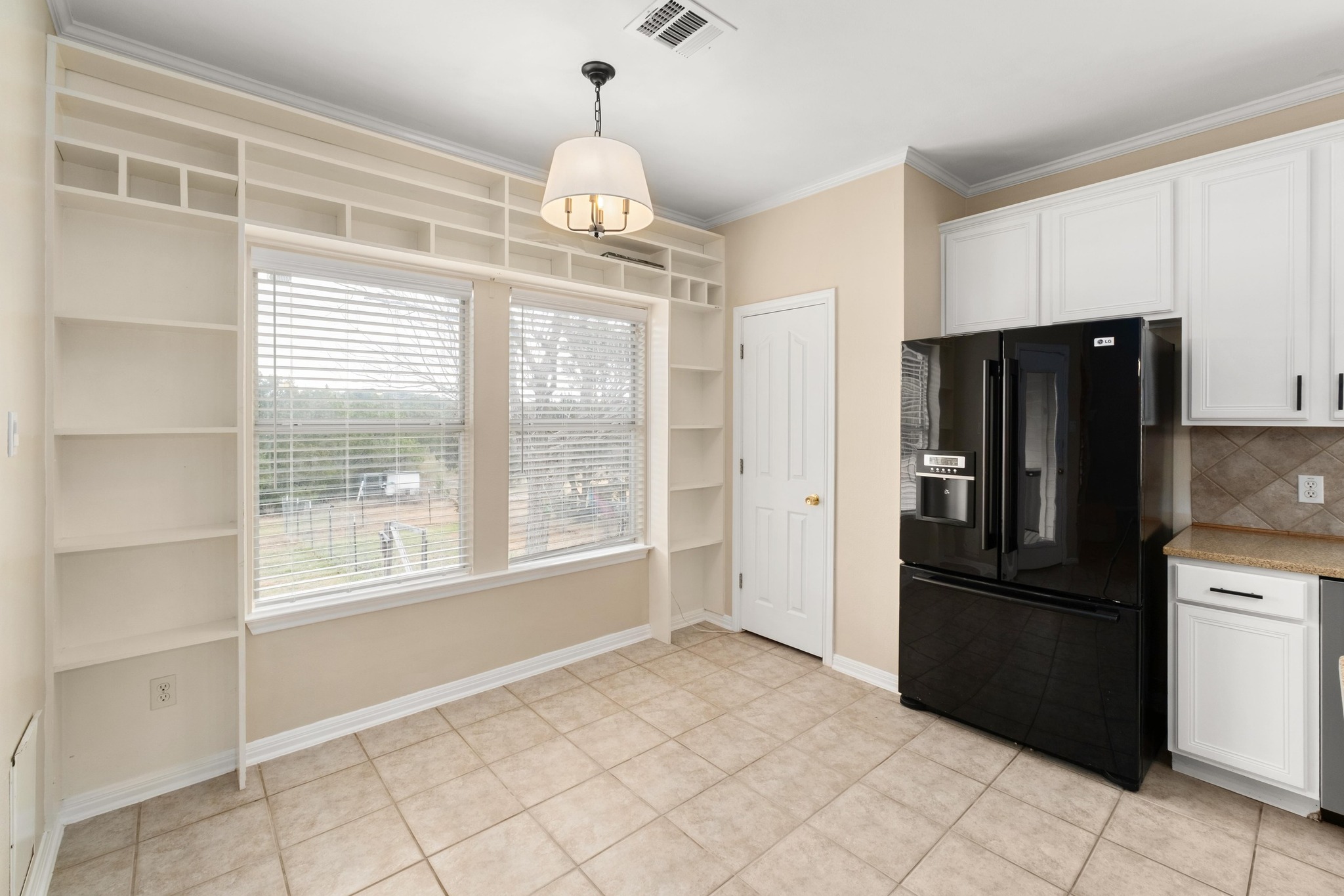 1021 Westland Ridge Road Dripping Springs, TX 78620 - Photo 29 of 33 Breakfast nook with decorative shelves overlooks back yard