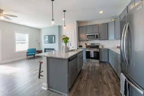 a kitchen with a sink stove and refrigerator