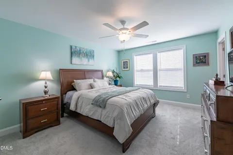 a bedroom with a bed dresser and a window