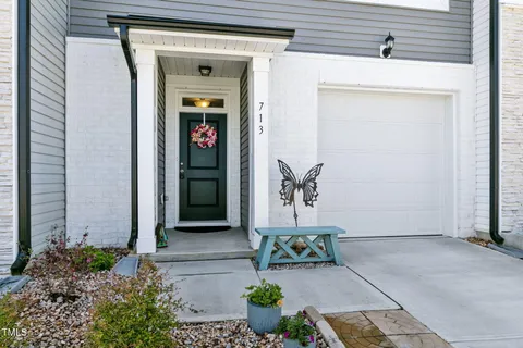 a front view of a house with potted plants