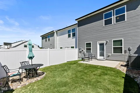 a house view with a sitting space and garden