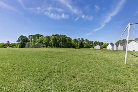 a view of a garden with a building in the background