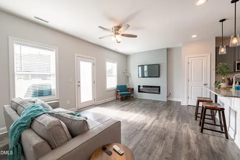 a living room with furniture and wooden floor