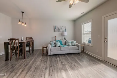 a living room with furniture and a wooden floor