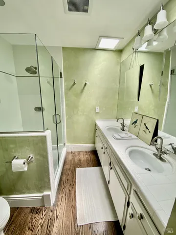 a spacious bedroom with a bed and a lamp