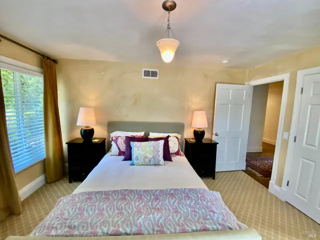 a bedroom with a bed and window