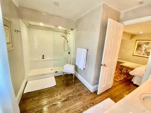 a large kitchen with kitchen island a large counter top space a sink stainless steel appliances and cabinets