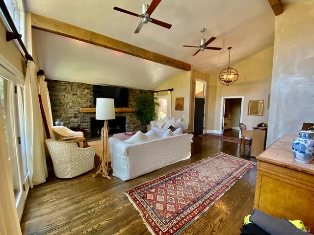 a living room with furniture fireplace and a large window