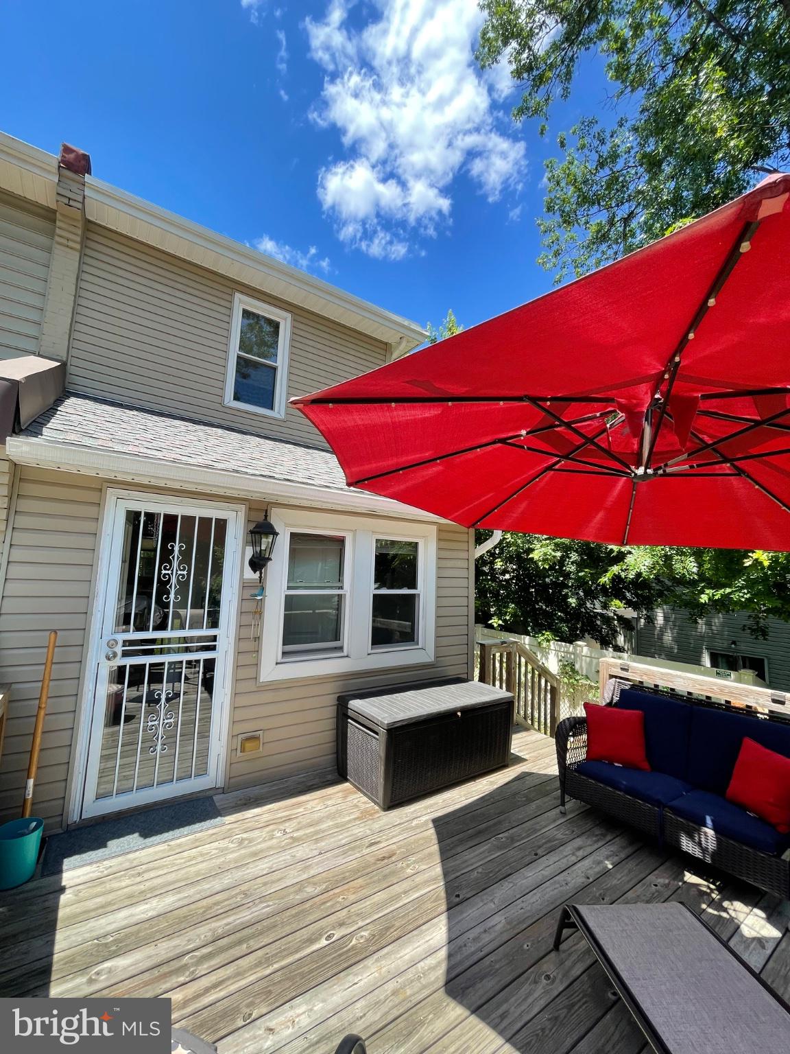 8129 Pine Road Philadelphia, PA 19111 - Photo 33 of 40 Sunny deck with vibrant red umbrella.