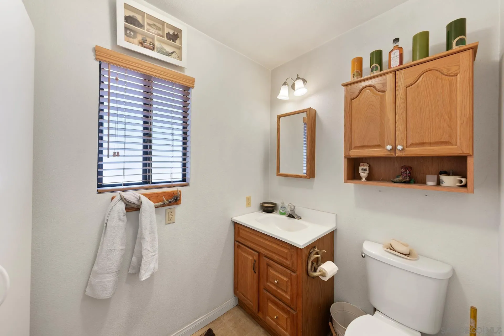 8203 Morris Ranch Road Pine Valley, CA 91962 - Photo 15 of 42 a bathroom with a toilet sink and mirror
