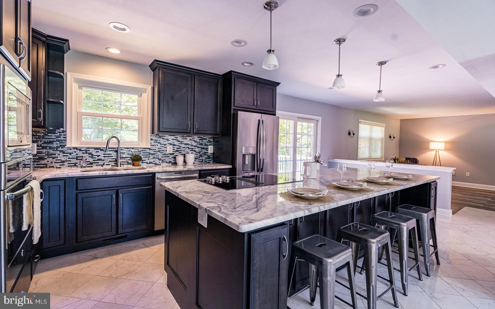 5705 Solomons Island Road St. Leonard, MD 20685 - Photo 11 of 46 a kitchen with a counter space a sink and cabinets