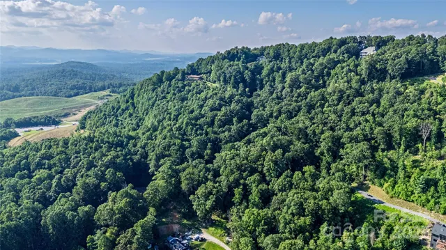 an aerial view of a houses with a yard