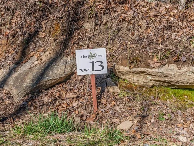 a sign that is sitting in the middle of a forest