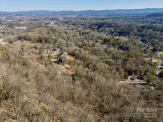 an aerial view of residential house and sandy dunes