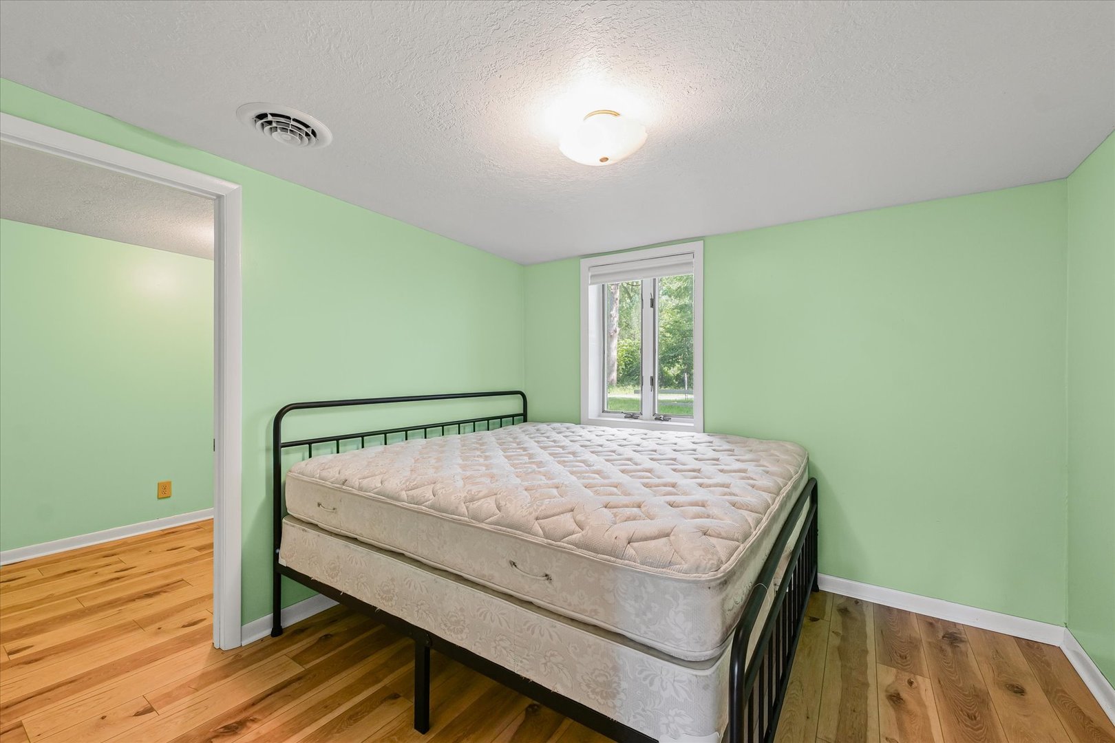 16322 Shangri La Road Oakwood, IL 61858 - Photo 13 of 42 a bedroom with a bed and wooden floor