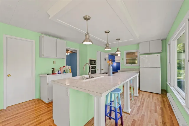 a kitchen with a sink stove and view living room