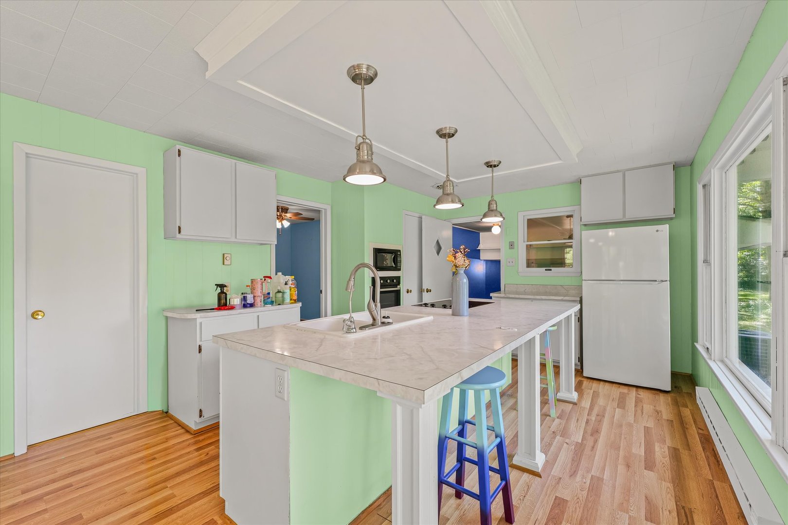 16322 Shangri La Road Oakwood, IL 61858 - Photo 20 of 42 a open kitchen with stainless steel appliances granite countertop a refrigerator a microwave oven a sink dishwasher and a dining table with wooden floor