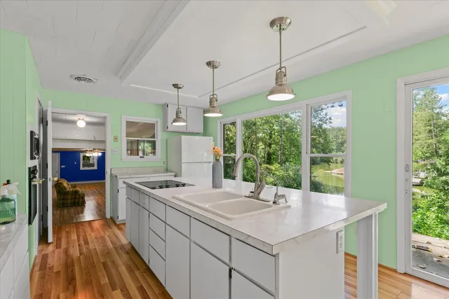 a view of a kitchen with a sink and a large window