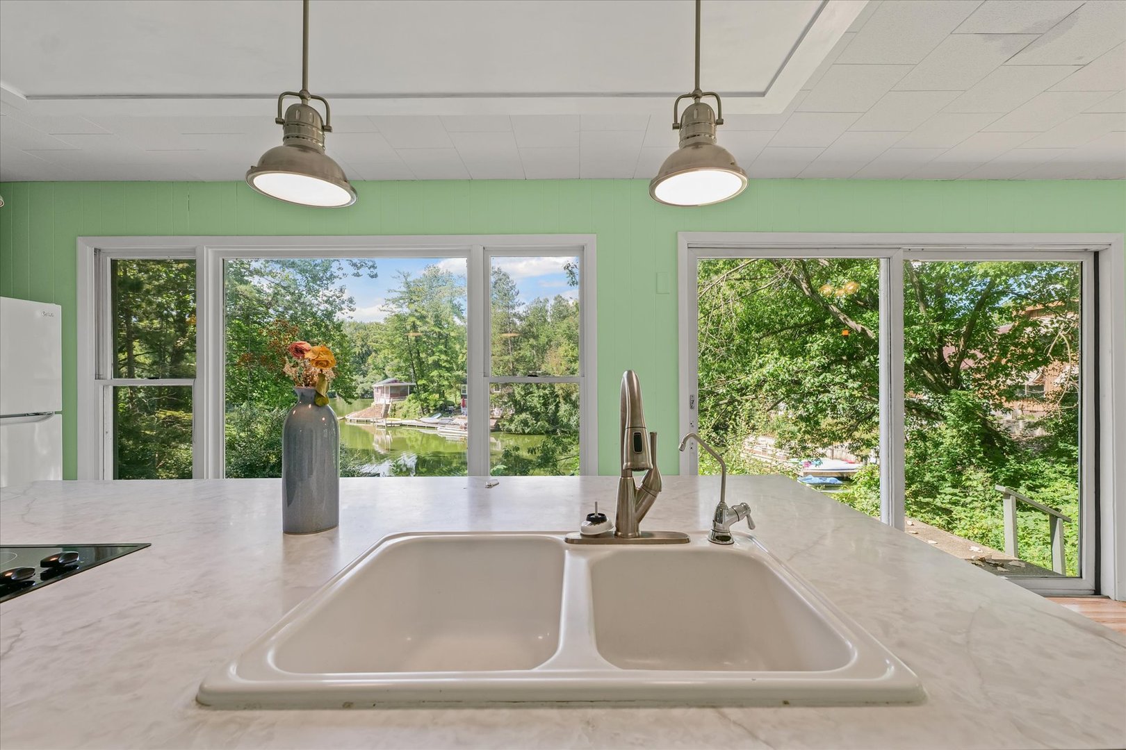 16322 Shangri La Road Oakwood, IL 61858 - Photo 22 of 42 a view of a kitchen with a sink and a large window