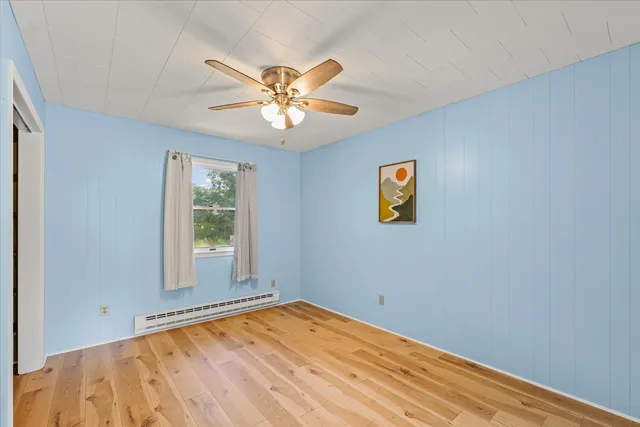 a view of a bedroom with a window and closet
