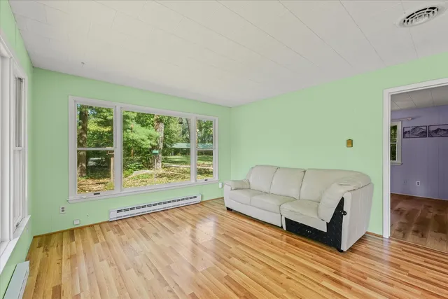 a living room with furniture and large windows