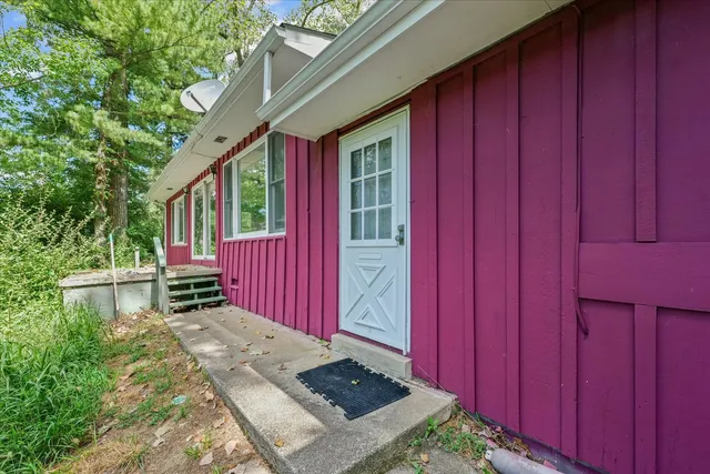 a view of backyard of house with green space