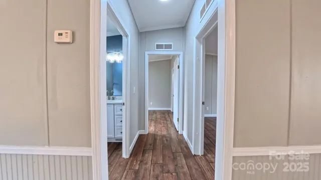 a view of a hallway with wooden floor
