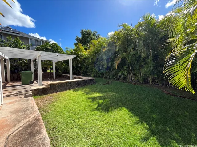 a view of a house with a yard patio and swimming pool
