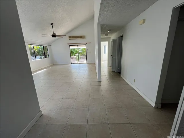 a view of hallway with furniture and a window