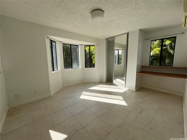 an empty room with entrance and windows