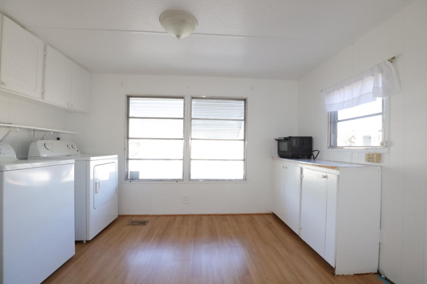 60 Wilson Way, Unit 70 Milpitas, CA 95035 - Photo 11 of 20 a kitchen with a white wooden cabinets and white appliances