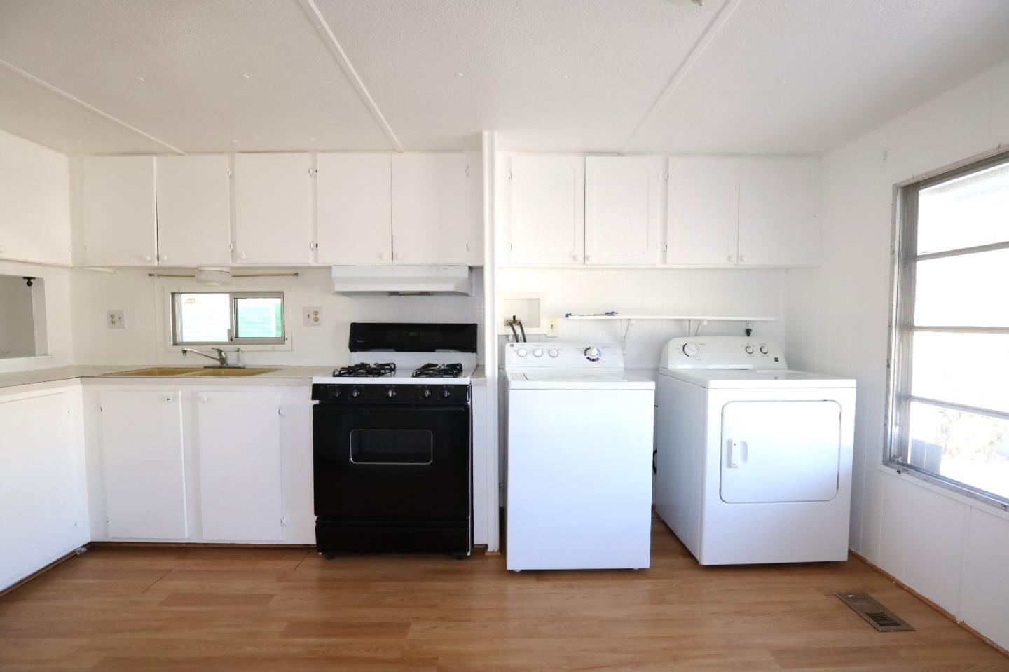 60 Wilson Way, Unit 70 Milpitas, CA 95035 - Photo 7 of 20 a kitchen with a refrigerator stove and white cabinets