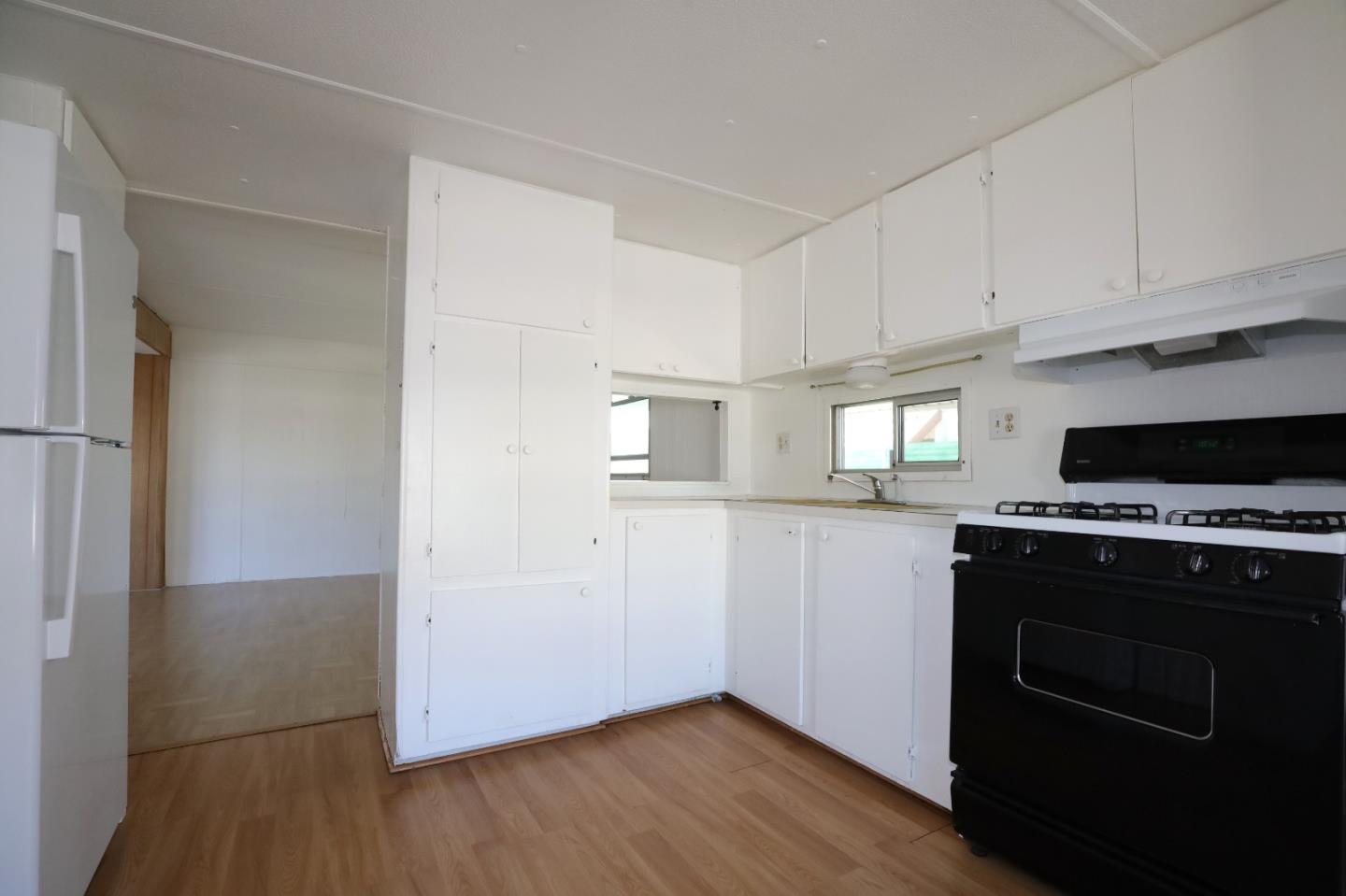 60 Wilson Way, Unit 70 Milpitas, CA 95035 - Photo 8 of 20 a kitchen with a stove and a refrigerator
