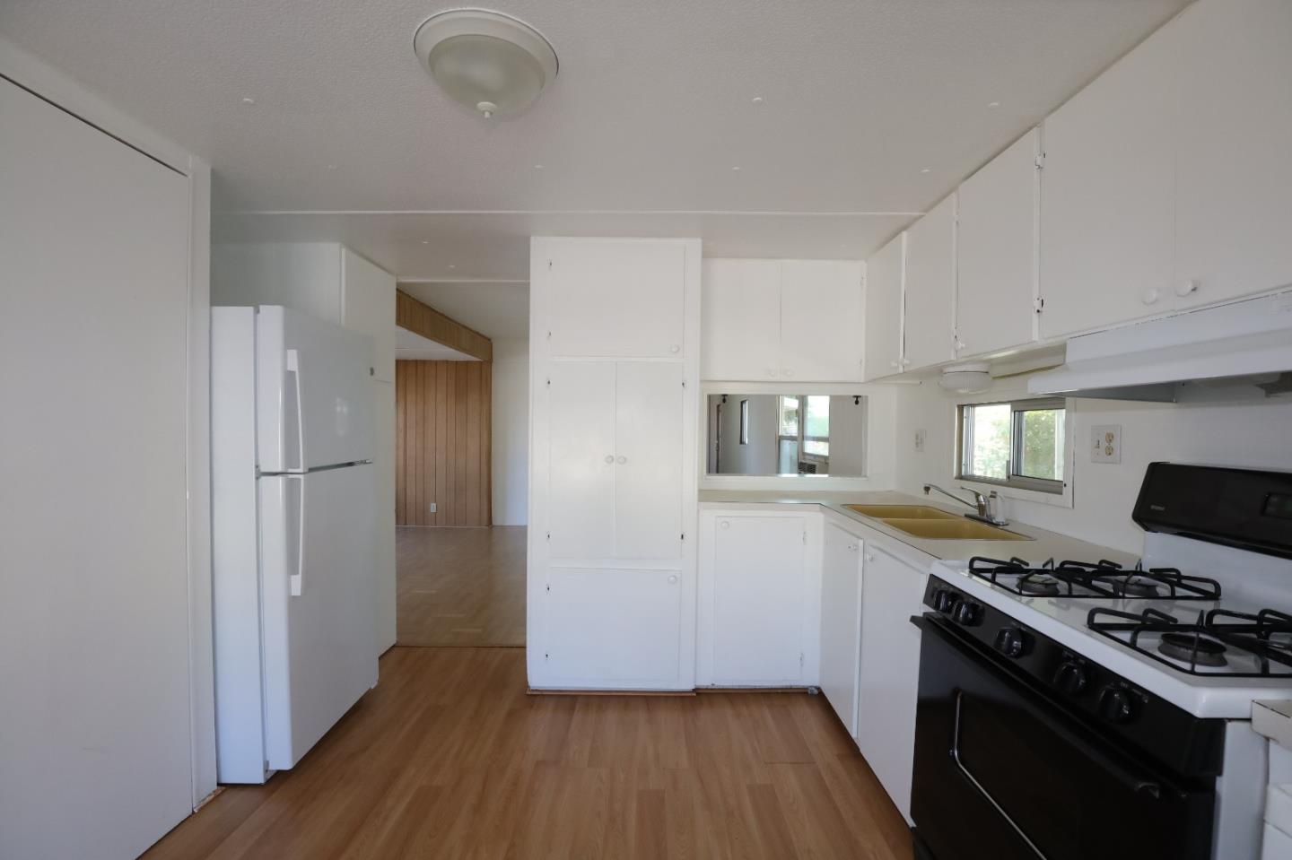 60 Wilson Way, Unit 70 Milpitas, CA 95035 - Photo 9 of 20 a kitchen with wooden floors and a stove top oven