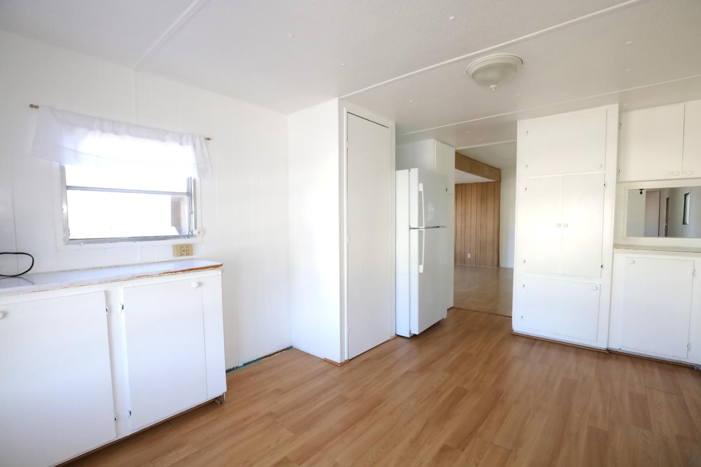 60 Wilson Way, Unit 70 Milpitas, CA 95035 - Photo 10 of 20 an empty room with wooden floor and windows