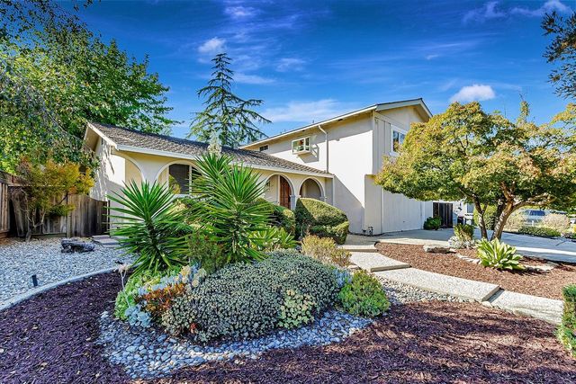 a front view of a house with garden