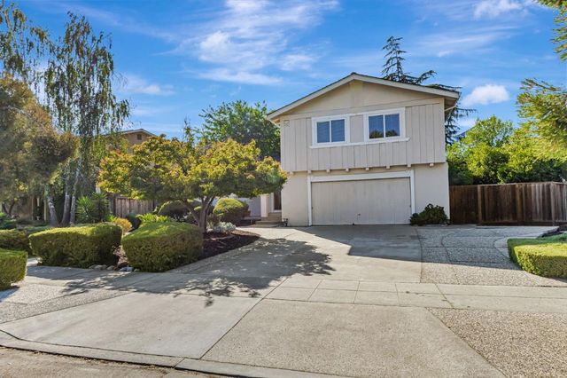 a view of a house with a yard and a garage