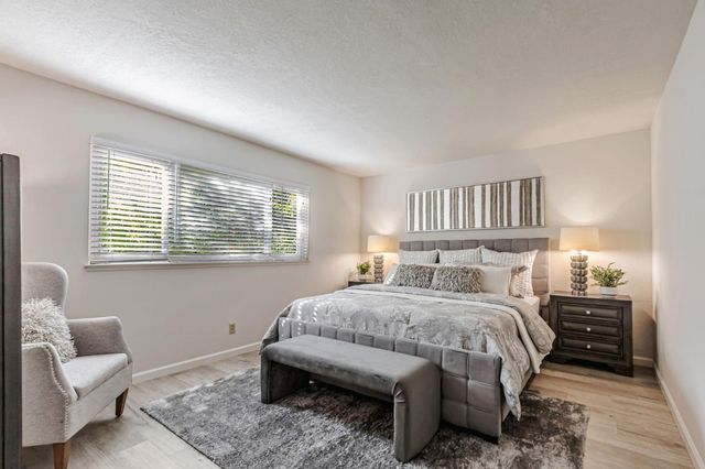 a bedroom with a bed and a couch