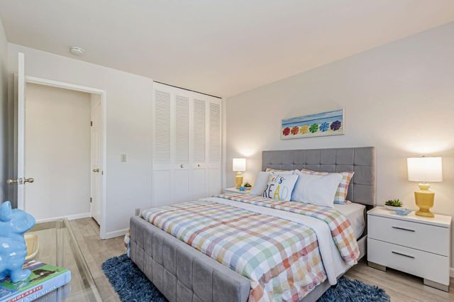 a bedroom with a bed and lamps